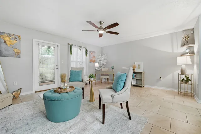 a living room with furniture and a chandelier