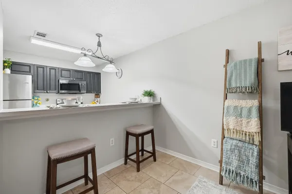 a kitchen with kitchen island stainless steel appliances a sink and cabinets