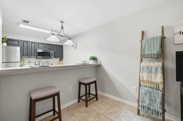a kitchen with kitchen island stainless steel appliances a sink and cabinets