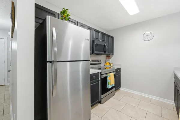 a kitchen with stainless steel appliances a refrigerator and a stove