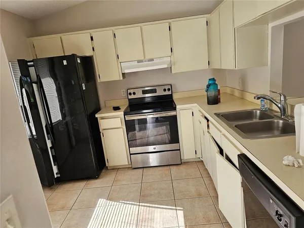 a kitchen with a refrigerator sink and stove