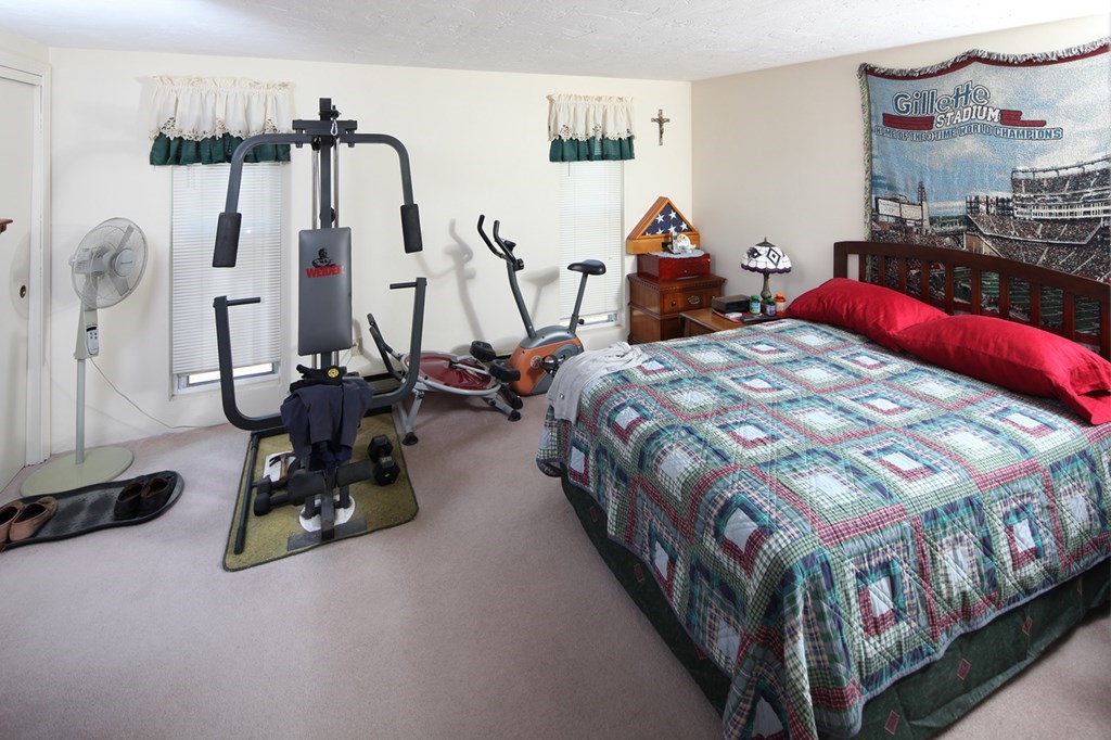 2 Tideview Path, Unit 9 Plymouth, MA 02360 - Photo 4 of 9 a bedroom with bed and glass door