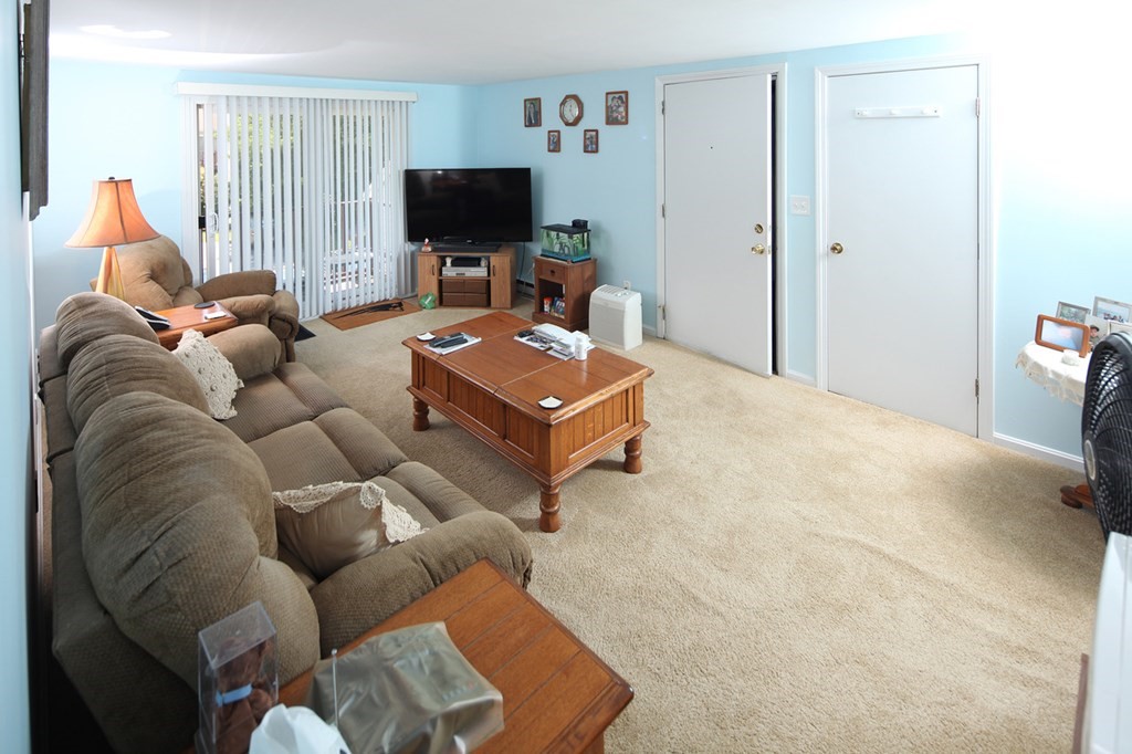 2 Tideview Path, Unit 9 Plymouth, MA 02360 - Photo 5 of 9 a living room with furniture and a flat screen tv