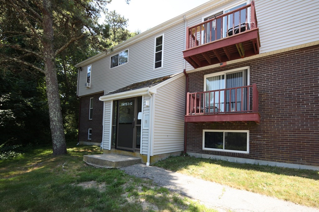 2 Tideview Path, Unit 9 Plymouth, MA 02360 - Photo 7 of 9 a front view of a house with a yard