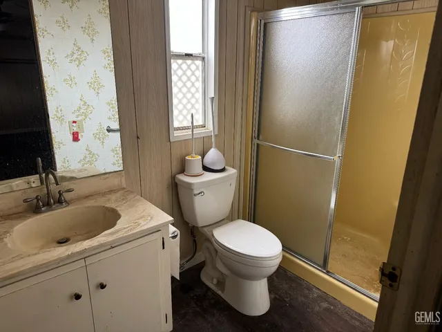 a white toilet sitting next to a bathroom sink