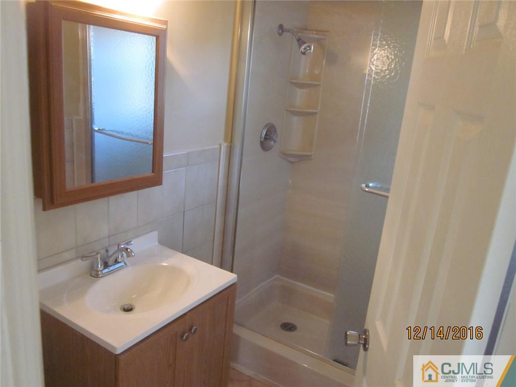 26 Dobson Road Edison, NJ 08817 - Photo 4 of 7 a bathroom with a shower a sink and mirror