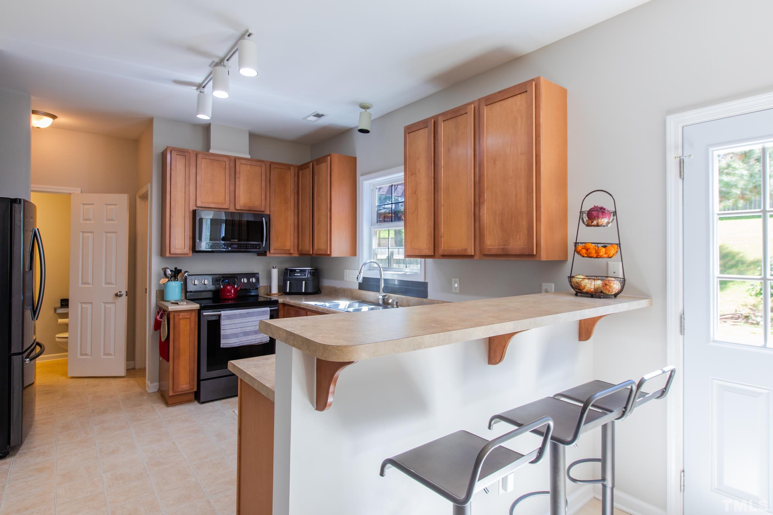 4228 Amber Stone Way Durham, NC 27704 - Photo 11 of 34 a kitchen with a sink a counter appliances and cabinets