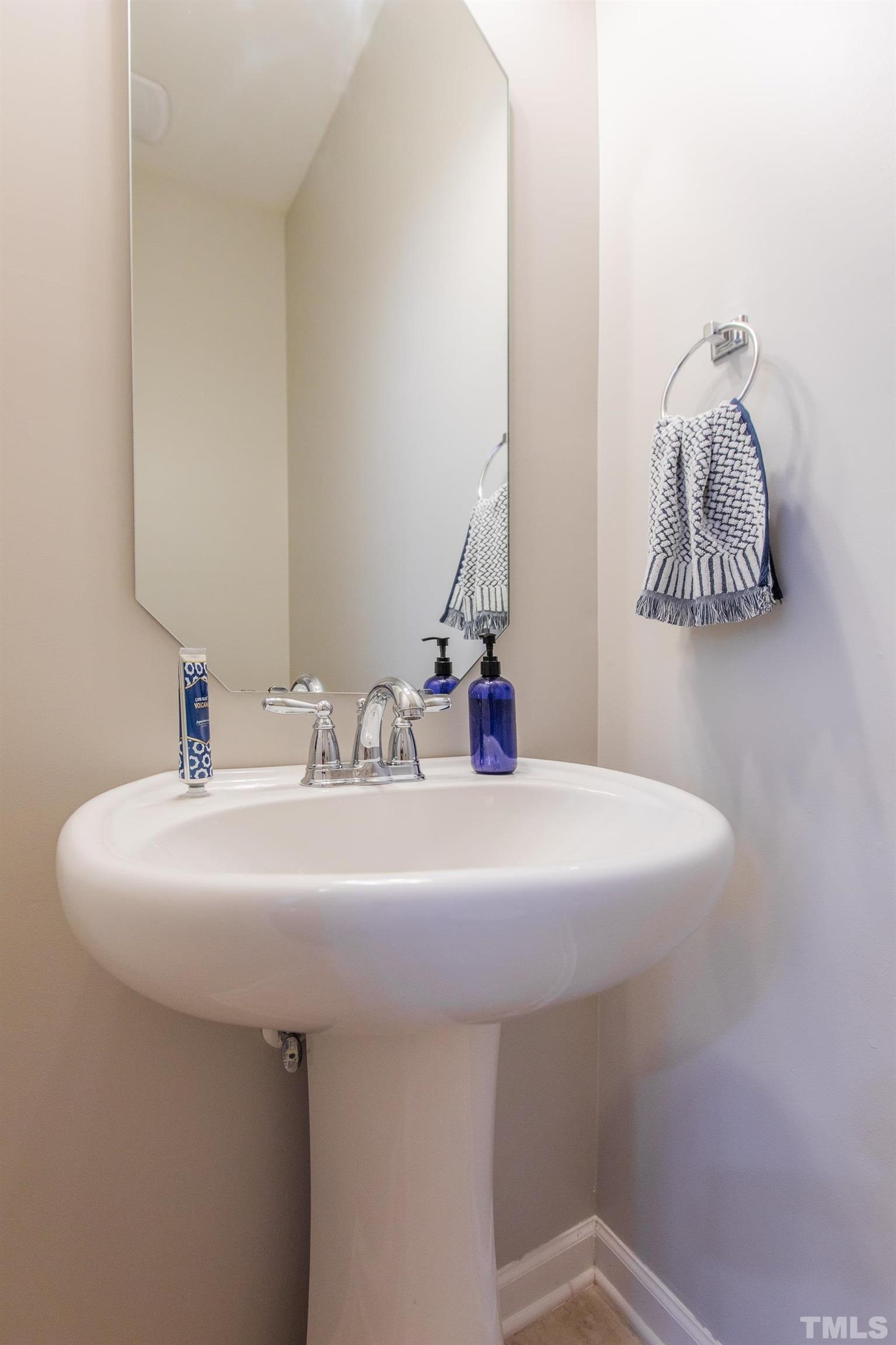 4228 Amber Stone Way Durham, NC 27704 - Photo 15 of 34 a bathroom with a sink and a mirror