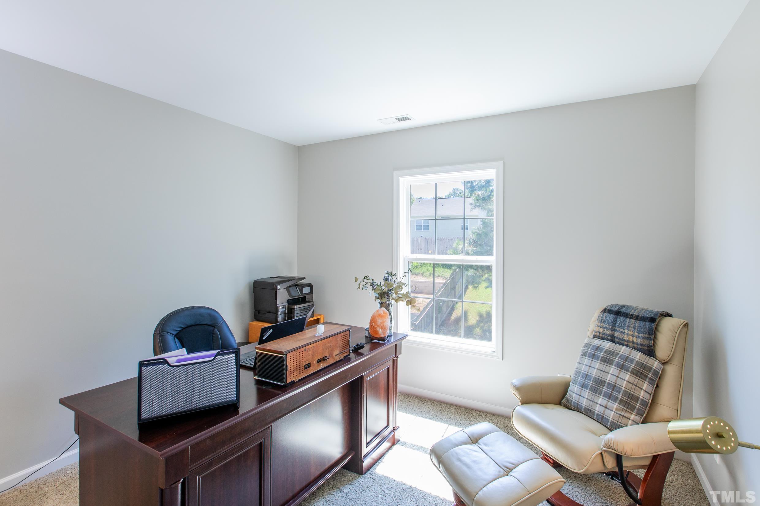 4228 Amber Stone Way Durham, NC 27704 - Photo 17 of 34 a living room with furniture and a window