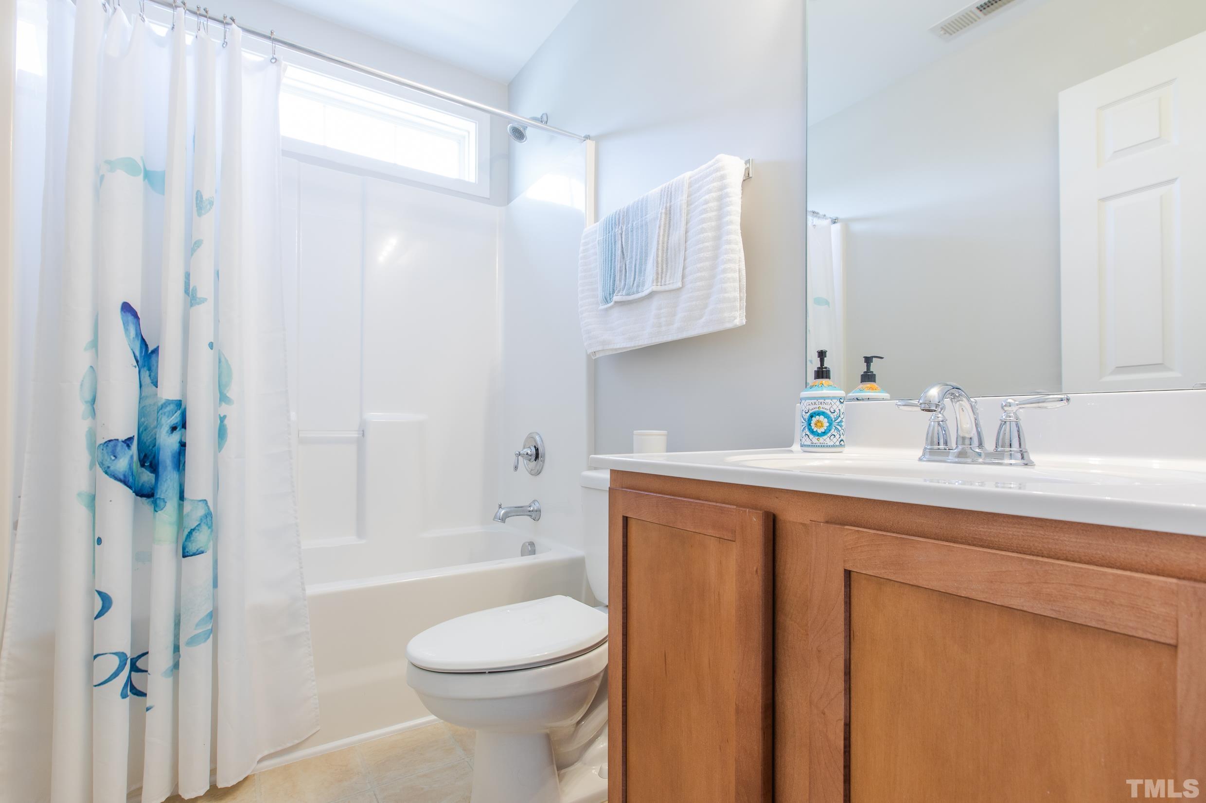 4228 Amber Stone Way Durham, NC 27704 - Photo 21 of 34 a bathroom with a sink toilet and shower