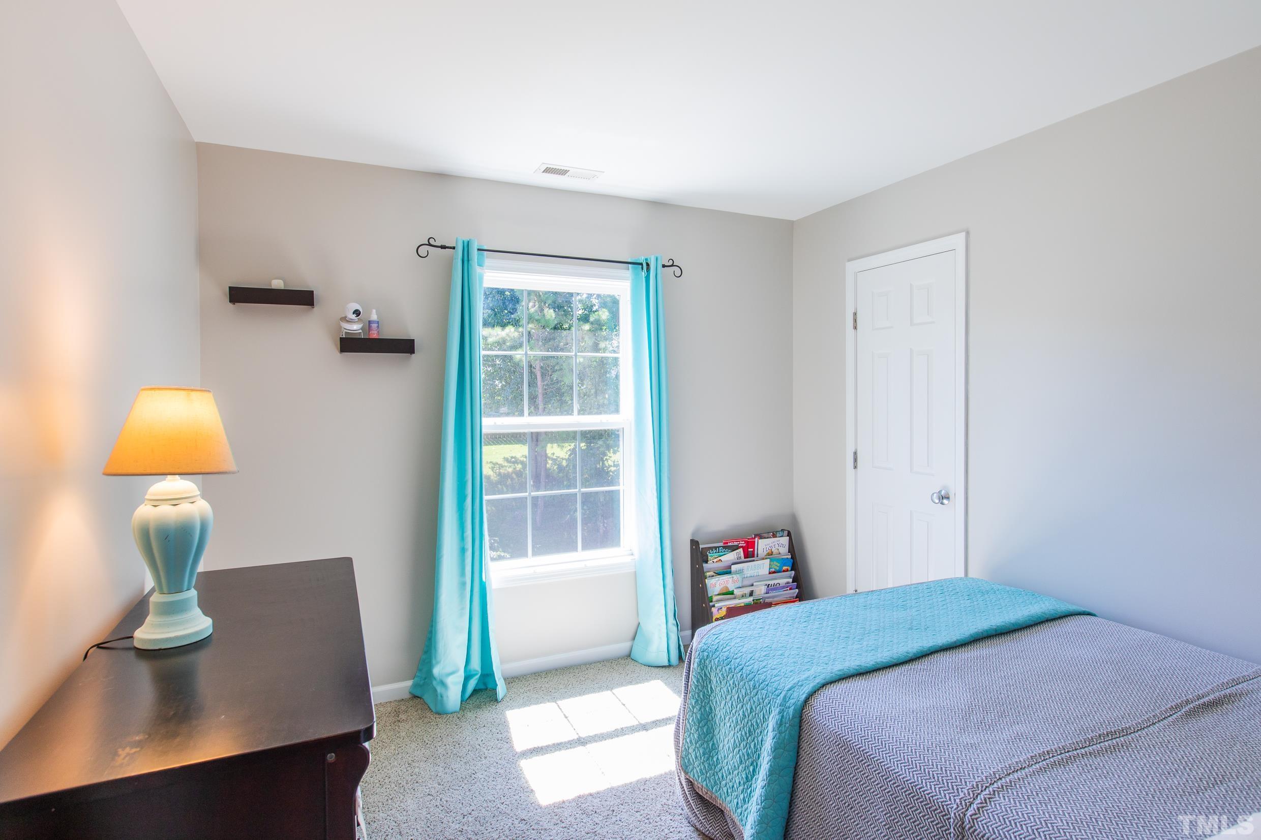 4228 Amber Stone Way Durham, NC 27704 - Photo 22 of 34 a bedroom with a bed and a window