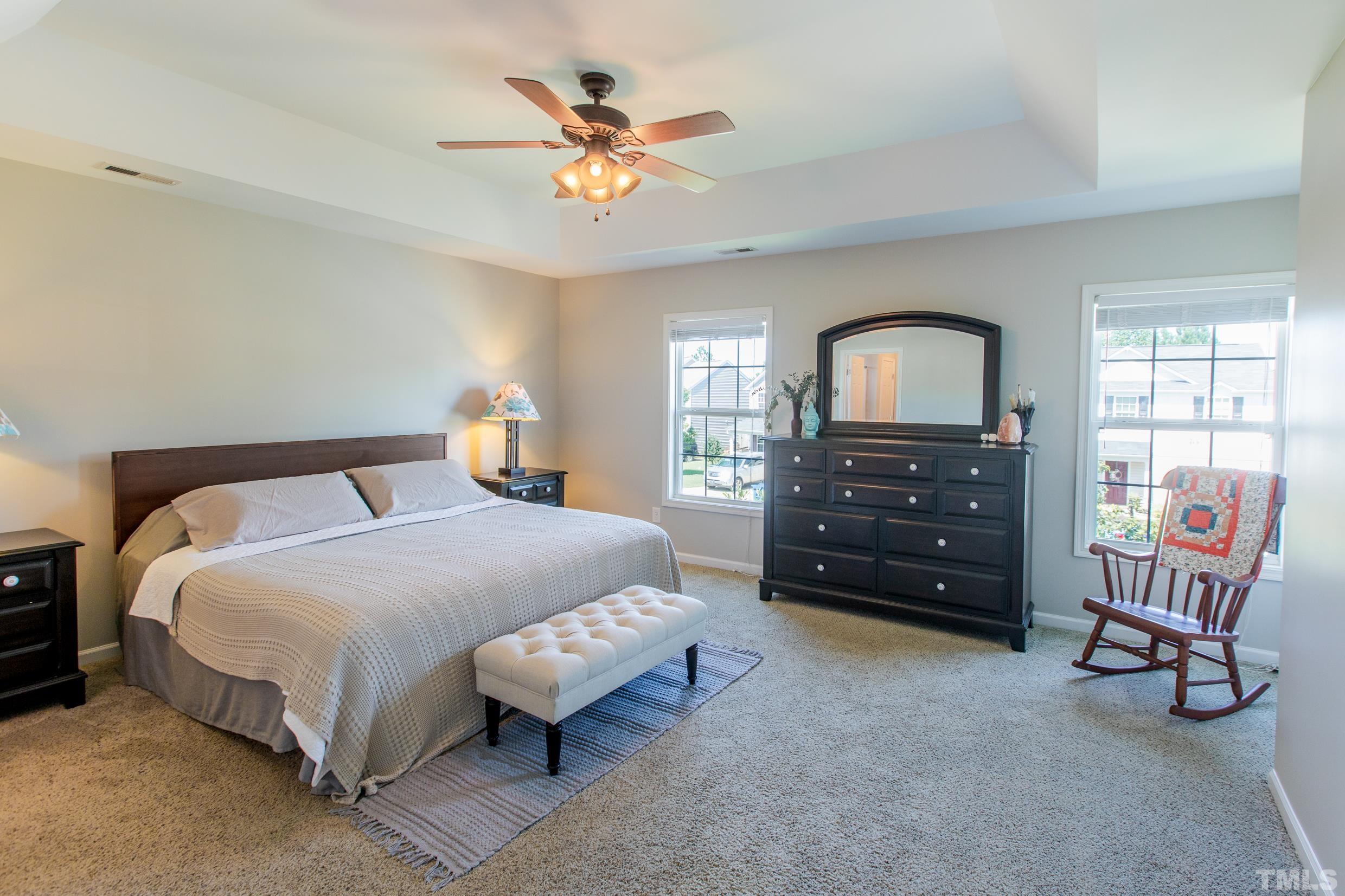 4228 Amber Stone Way Durham, NC 27704 - Photo 26 of 34 a bedroom with a bed and a chandelier