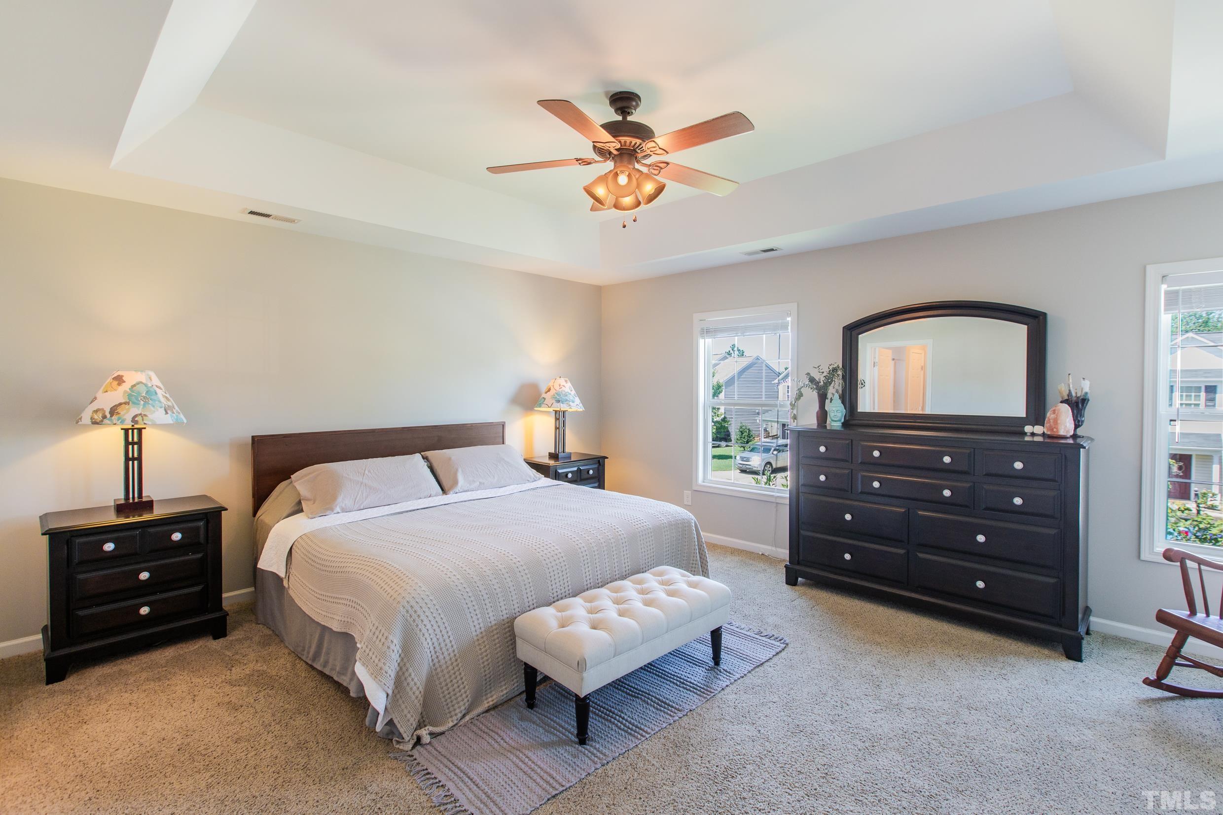 4228 Amber Stone Way Durham, NC 27704 - Photo 27 of 34 a bedroom with a bed and a dresser