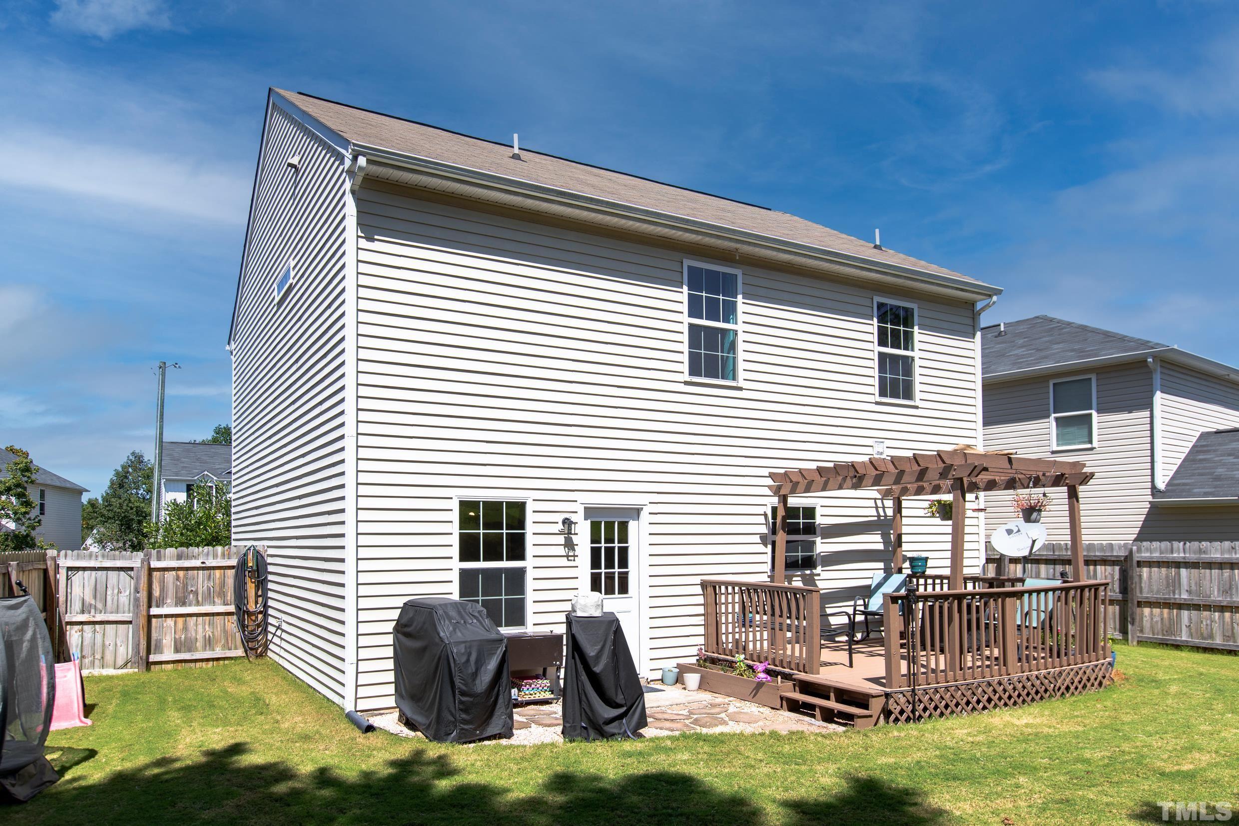 4228 Amber Stone Way Durham, NC 27704 - Photo 32 of 34 a backyard of a house with table and chairs