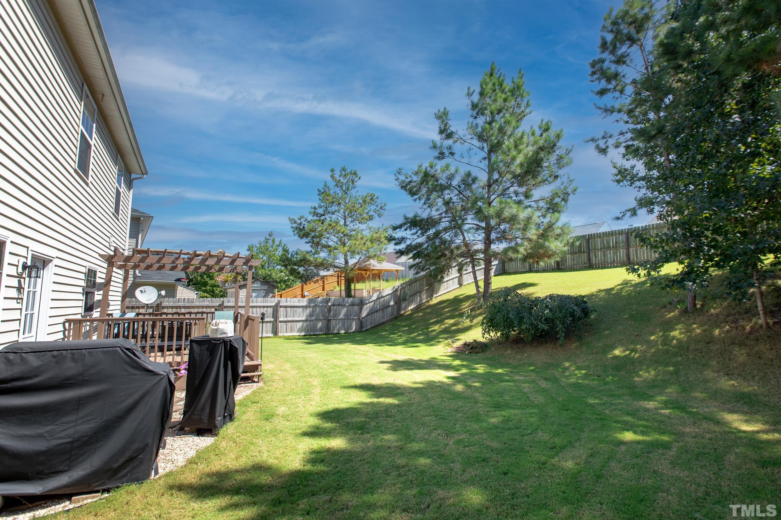 4228 Amber Stone Way Durham, NC 27704 - Photo 34 of 34 a view of a swimming pool with a patio and a yard