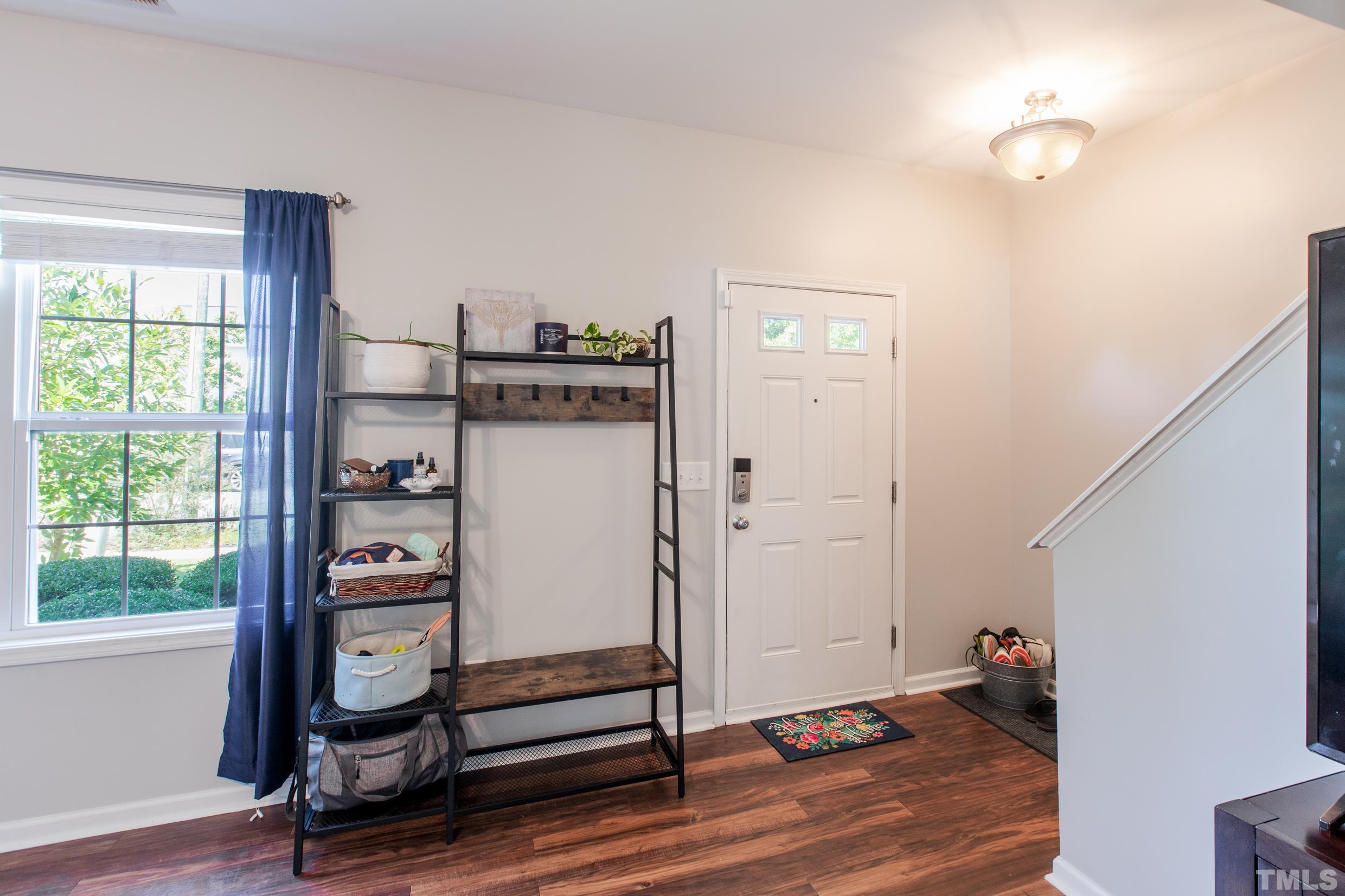 4228 Amber Stone Way Durham, NC 27704 - Photo 4 of 34 a view of a room with wooden floor and windows