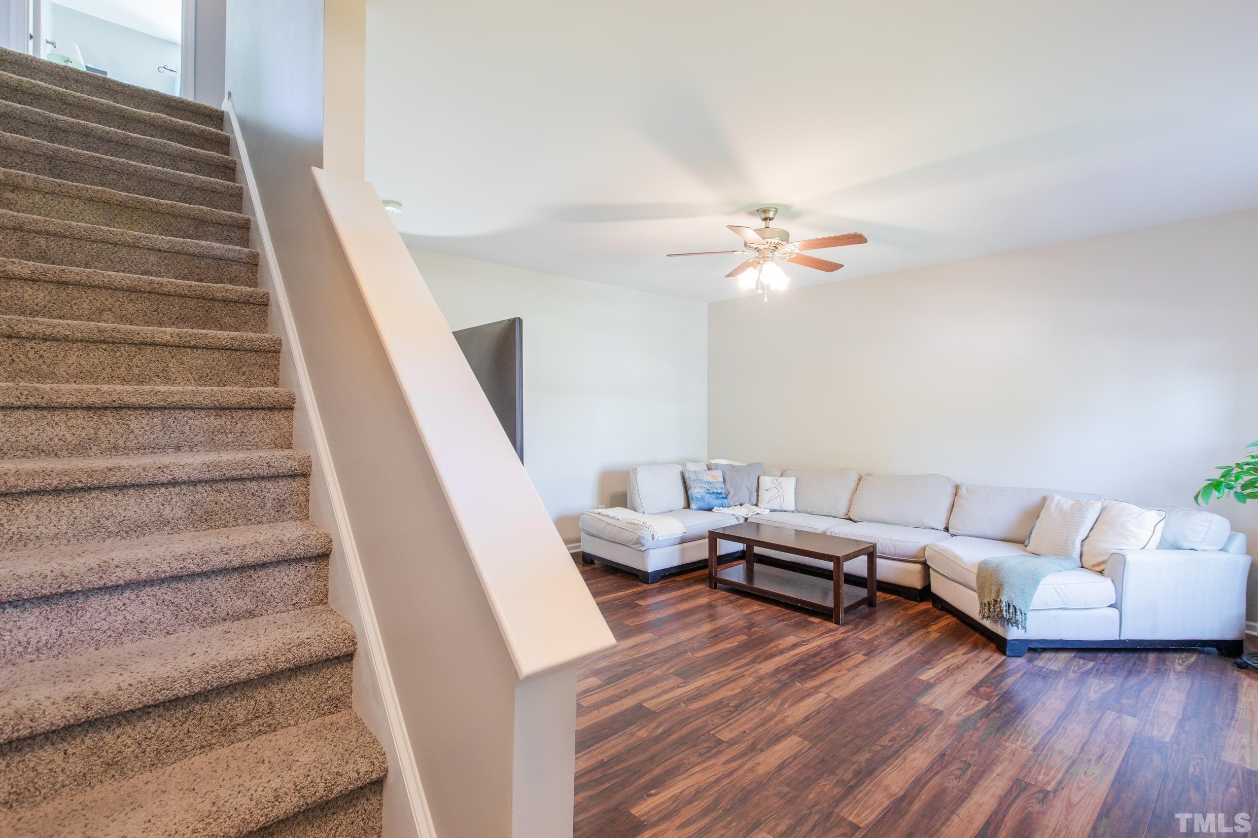 4228 Amber Stone Way Durham, NC 27704 - Photo 5 of 34 a living room with furniture and a chandelier