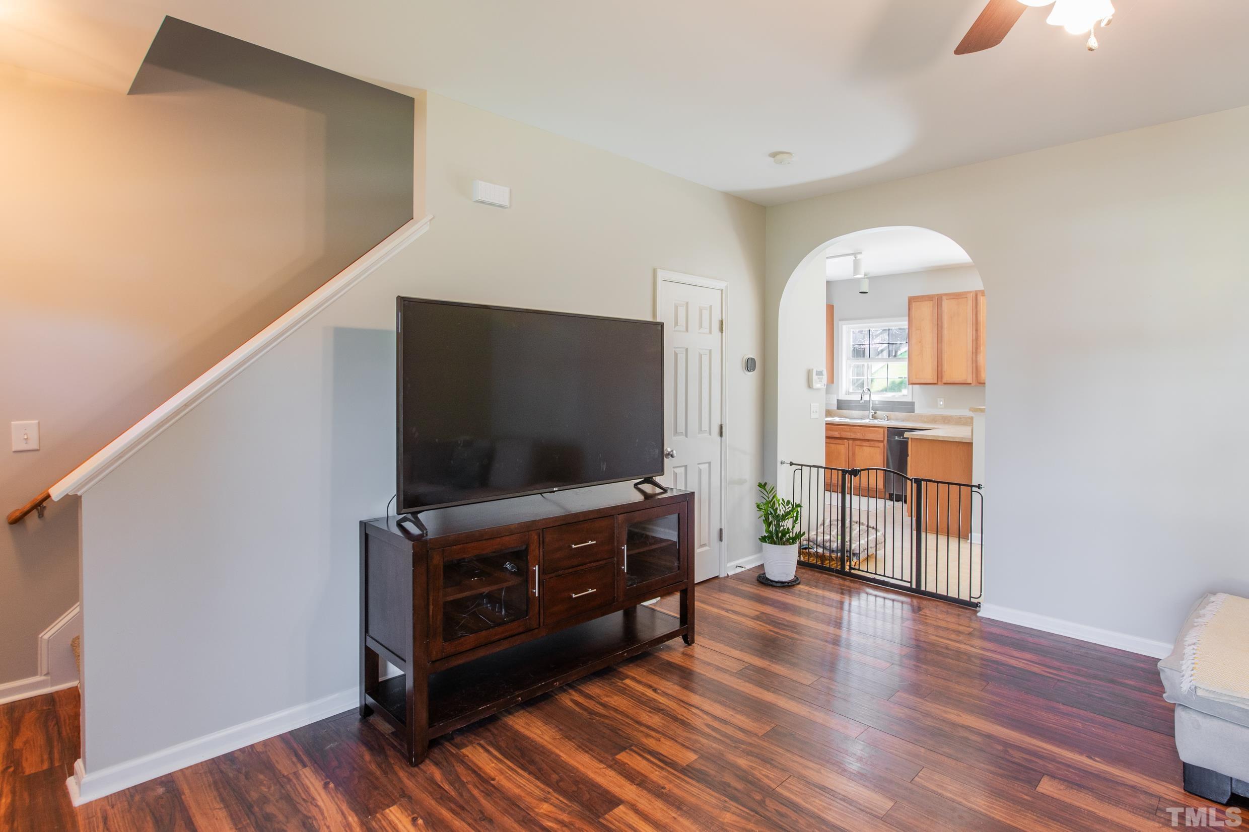 4228 Amber Stone Way Durham, NC 27704 - Photo 8 of 34 a living room with furniture and a flat screen tv