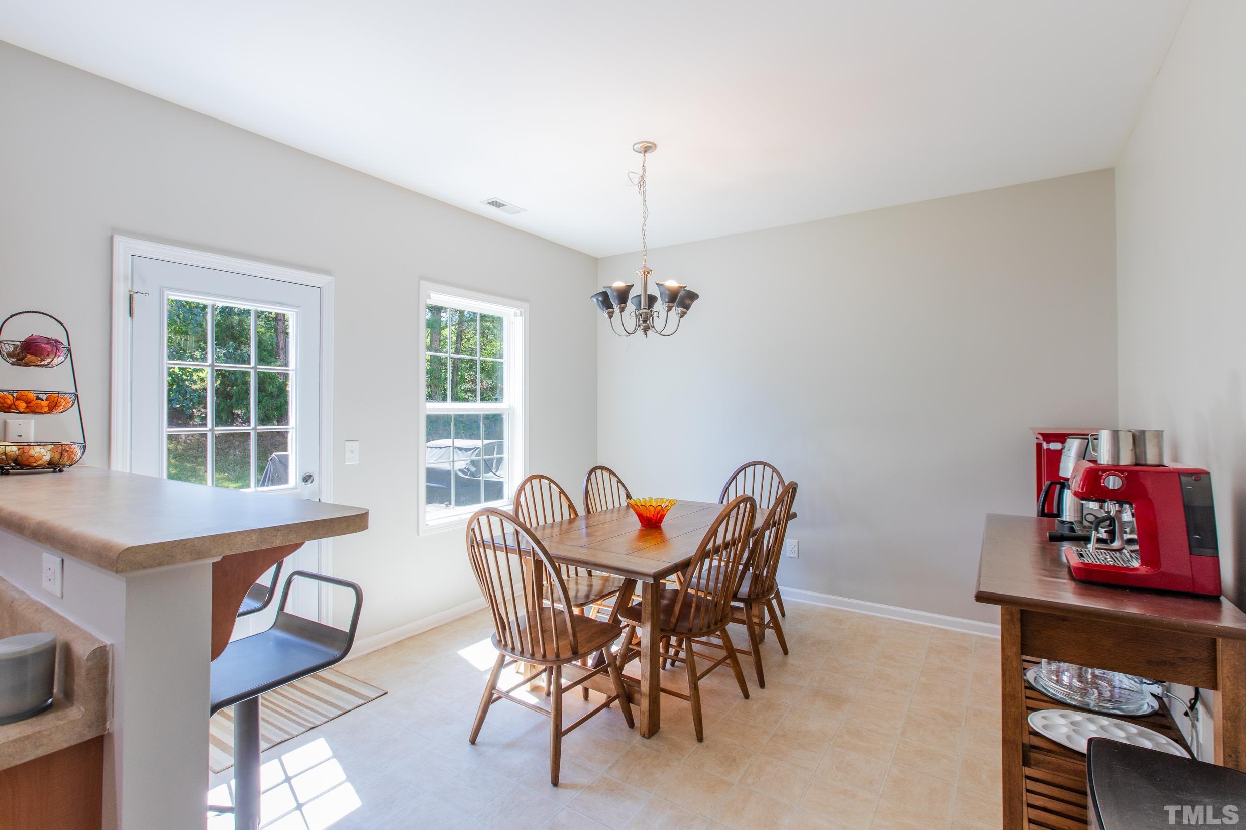 4228 Amber Stone Way Durham, NC 27704 - Photo 9 of 34 a view of a dining room with furniture window and outside view