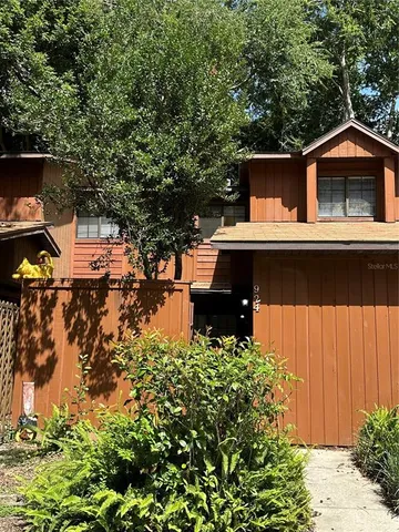 a front view of house with yard and trees around