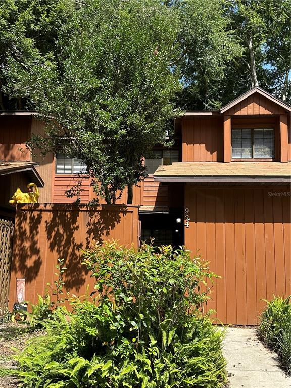 a front view of house with yard and trees around
