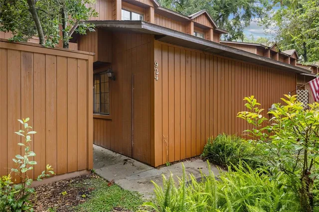 a backyard of a house with potted plants