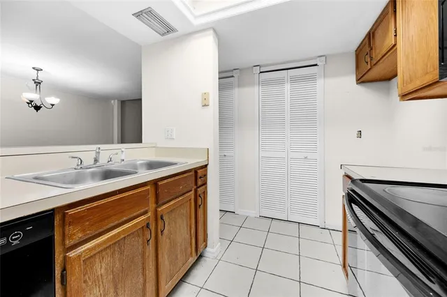 a kitchen with a sink cabinets and stainless steel appliances