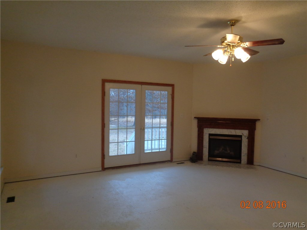 20172 Horseshoe Road Carson, VA 23830 - Photo 13 of 27 a view of a livingroom with a chandelier fan and a fireplace