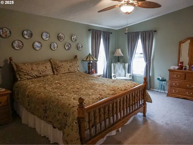 a bed sitting in a bedroom next to a window