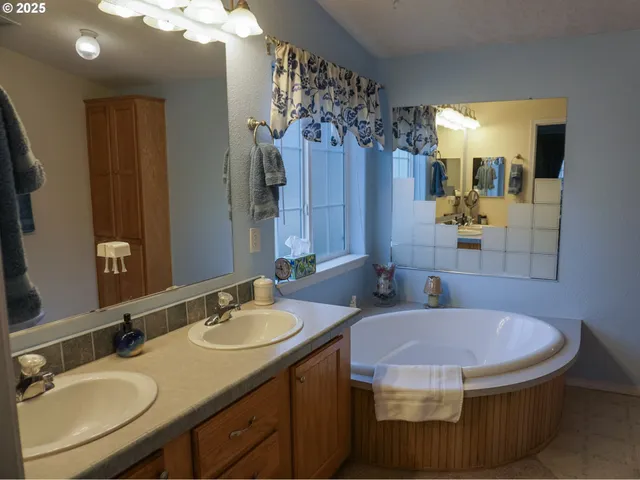 a bathroom with a sink double vanity granite and a mirror