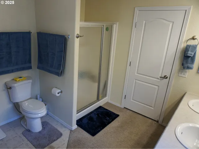 a bathroom with a toilet and a shower