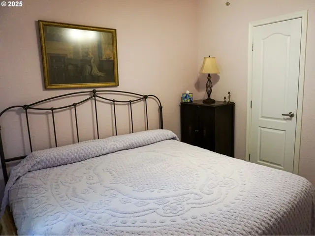 a large bed in a bedroom with a mirror