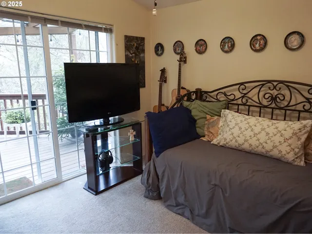 a bedroom with a bed and a flat screen tv