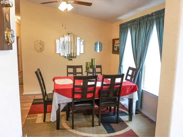 a view of a dining room with furniture and a chandelier