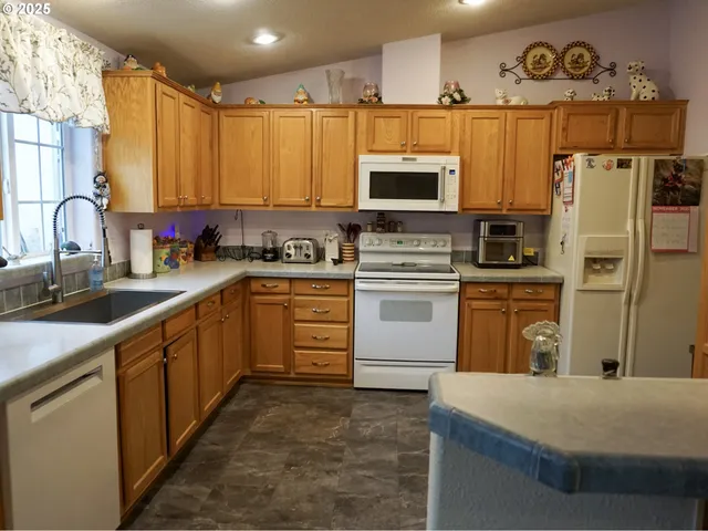 a kitchen with stainless steel appliances a sink cabinets and microwave