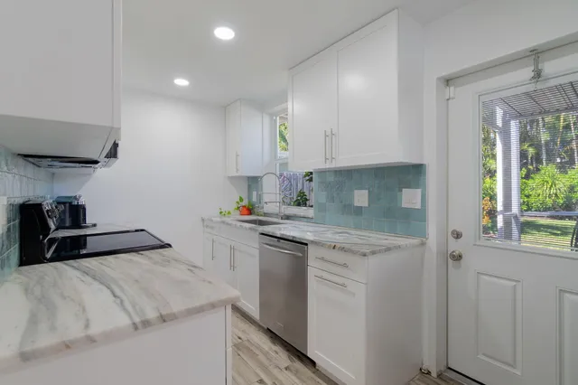 a kitchen with a sink stove and cabinets