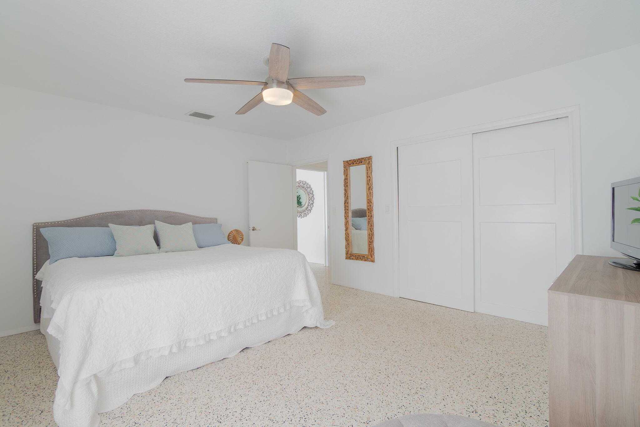 651 Ocean Inlet Drive Boynton Beach, FL 33435 - Photo 16 of 44 a spacious bedroom with a bed and a chandelier
