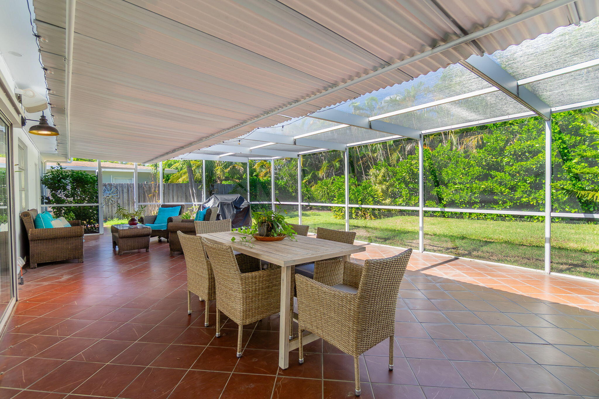 651 Ocean Inlet Drive Boynton Beach, FL 33435 - Photo 22 of 44 a view of a patio with a table chairs and a small yard