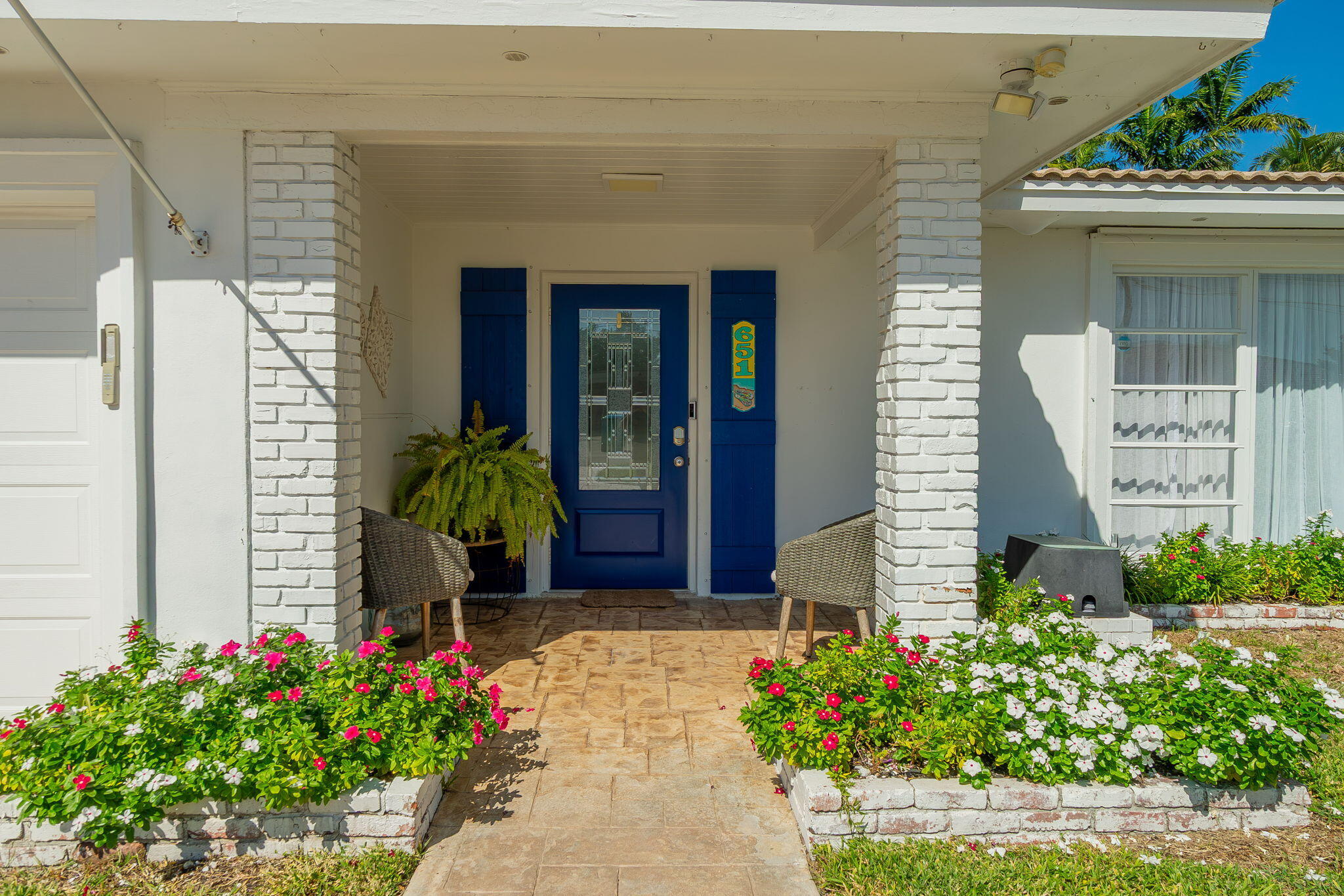 651 Ocean Inlet Drive Boynton Beach, FL 33435 - Photo 3 of 44 a front view of a house with a garden
