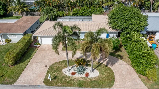 an aerial view of a house with a yard and trees
