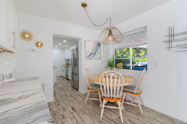 a view of a dining room with furniture wooden floor and a chandelier