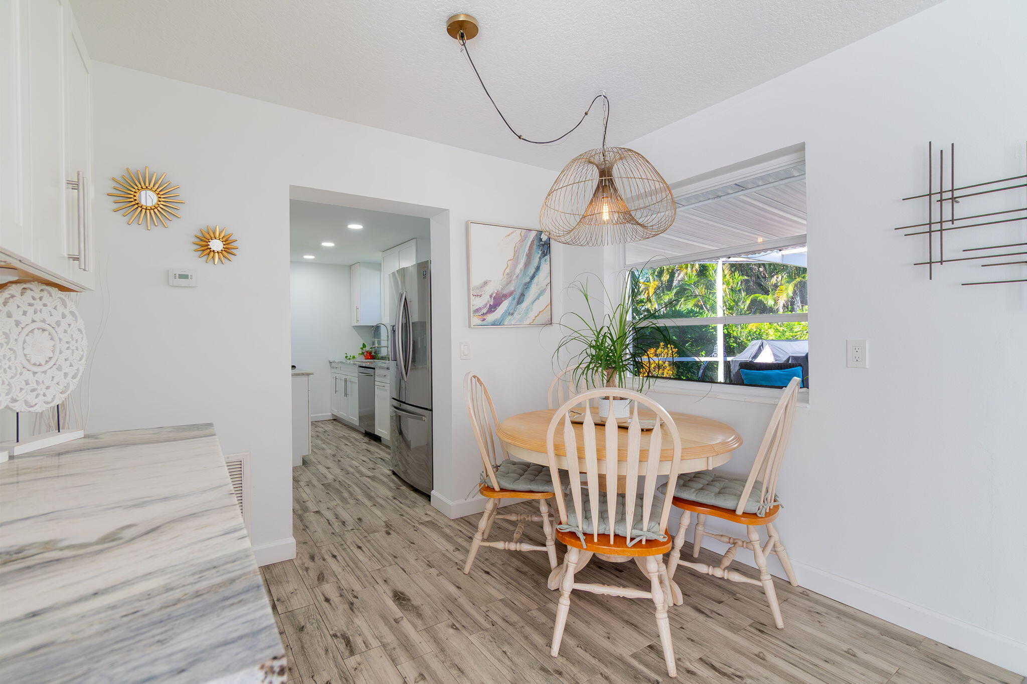 651 Ocean Inlet Drive Boynton Beach, FL 33435 - Photo 10 of 44 a view of a dining room with furniture wooden floor and a chandelier