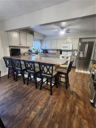 a kitchen with a table chairs and a refrigerator