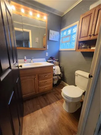 a bathroom with a sink toilet and mirror