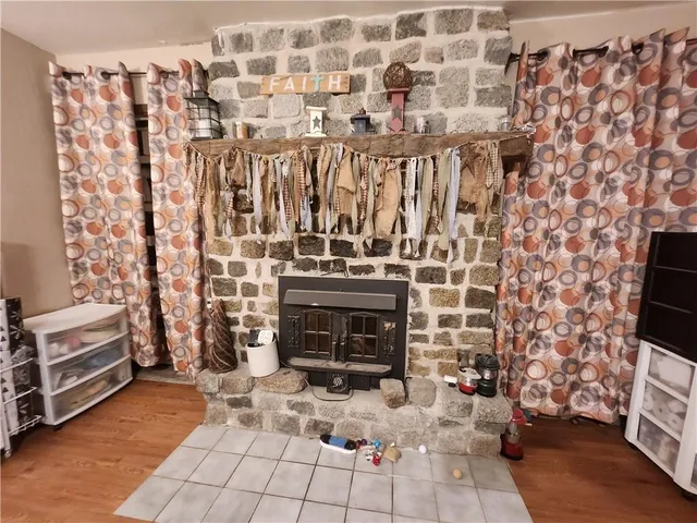 a living room with a fireplace and a rug