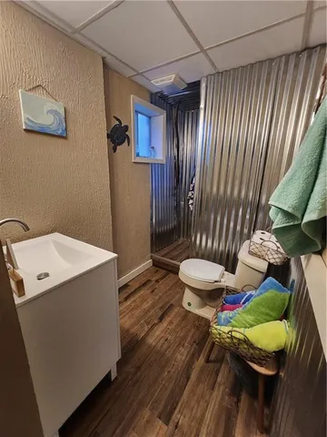 a bathroom with a sink mirror vanity and toilet