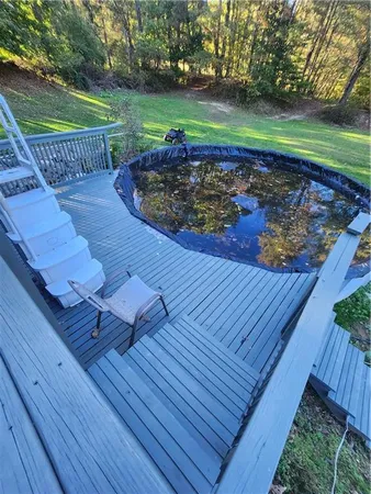 a view of a yard with wooden deck
