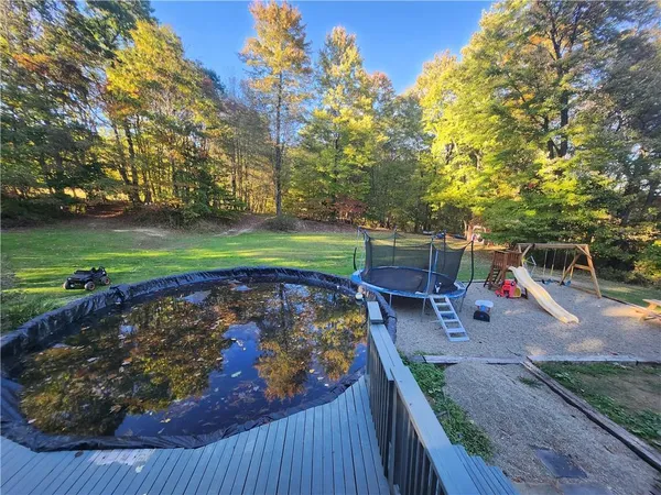 a view of a backyard with wooden fence