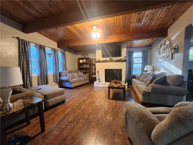 a living room with furniture fireplace and a large window