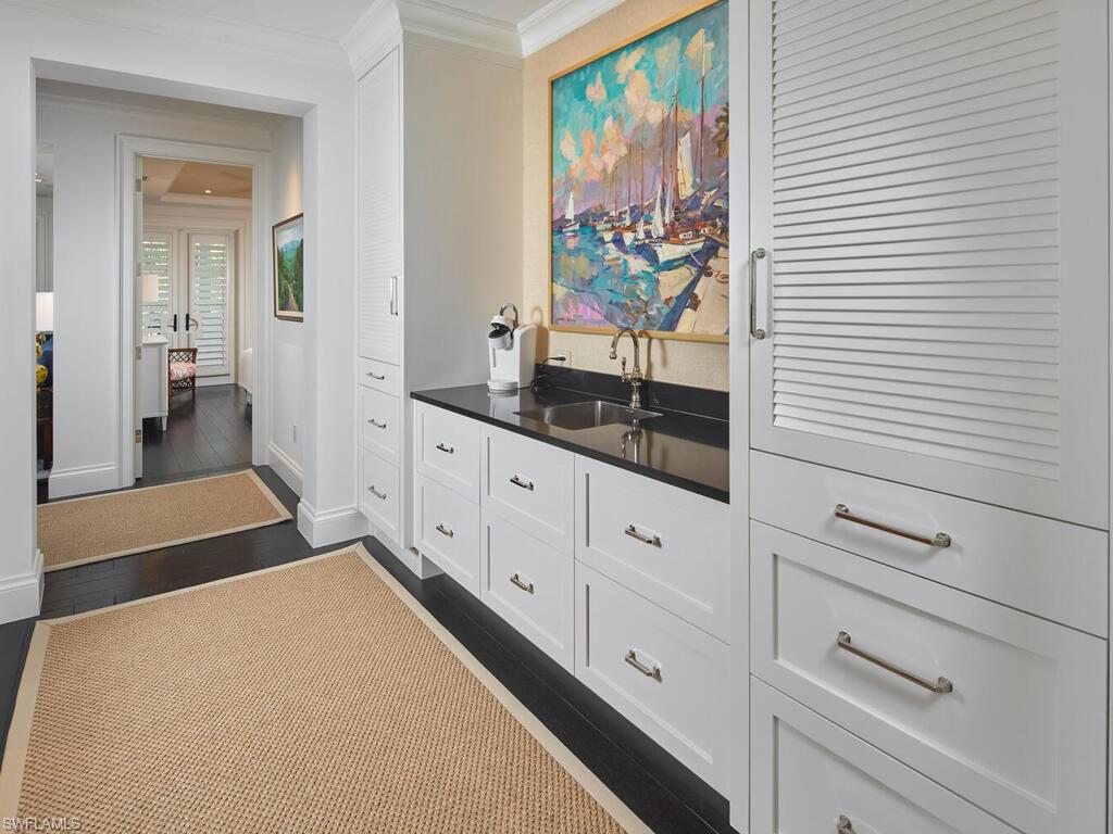 167 4th Street North Naples, FL 34102 - Photo 14 of 33 a spacious bathroom with a double vanity sink and a large mirror
